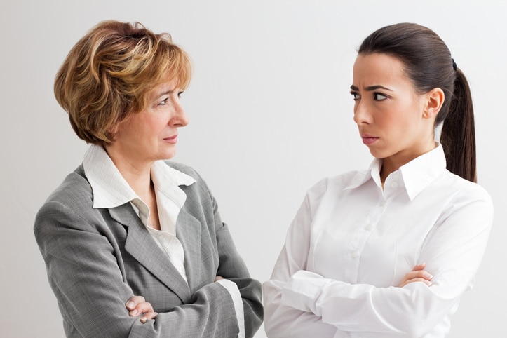 older woman gaslighting a coworker