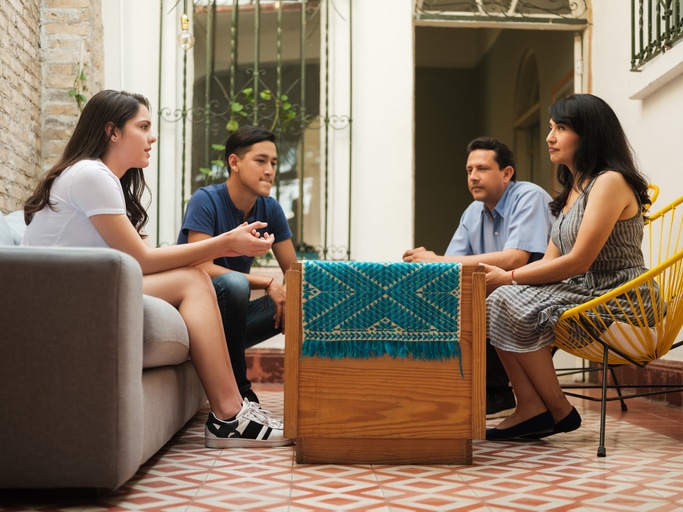 teenager discussing her mental health with her family