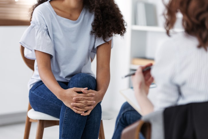 woman consulting her psychiatrist about TMS