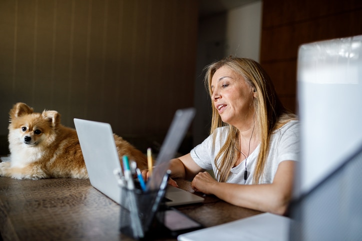 woman on virtual counseling appointment with dog
